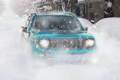 New Jeep Renegade Driving on The Heavy Snow During Winter