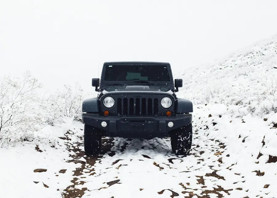 Black Jeep Wrangler Off-road on the Snow