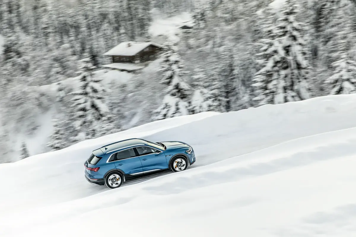 Blue Audi Q8 e-tron Driving Trough Snow