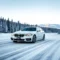 BMW Sedan Cruising on The Snowy Road